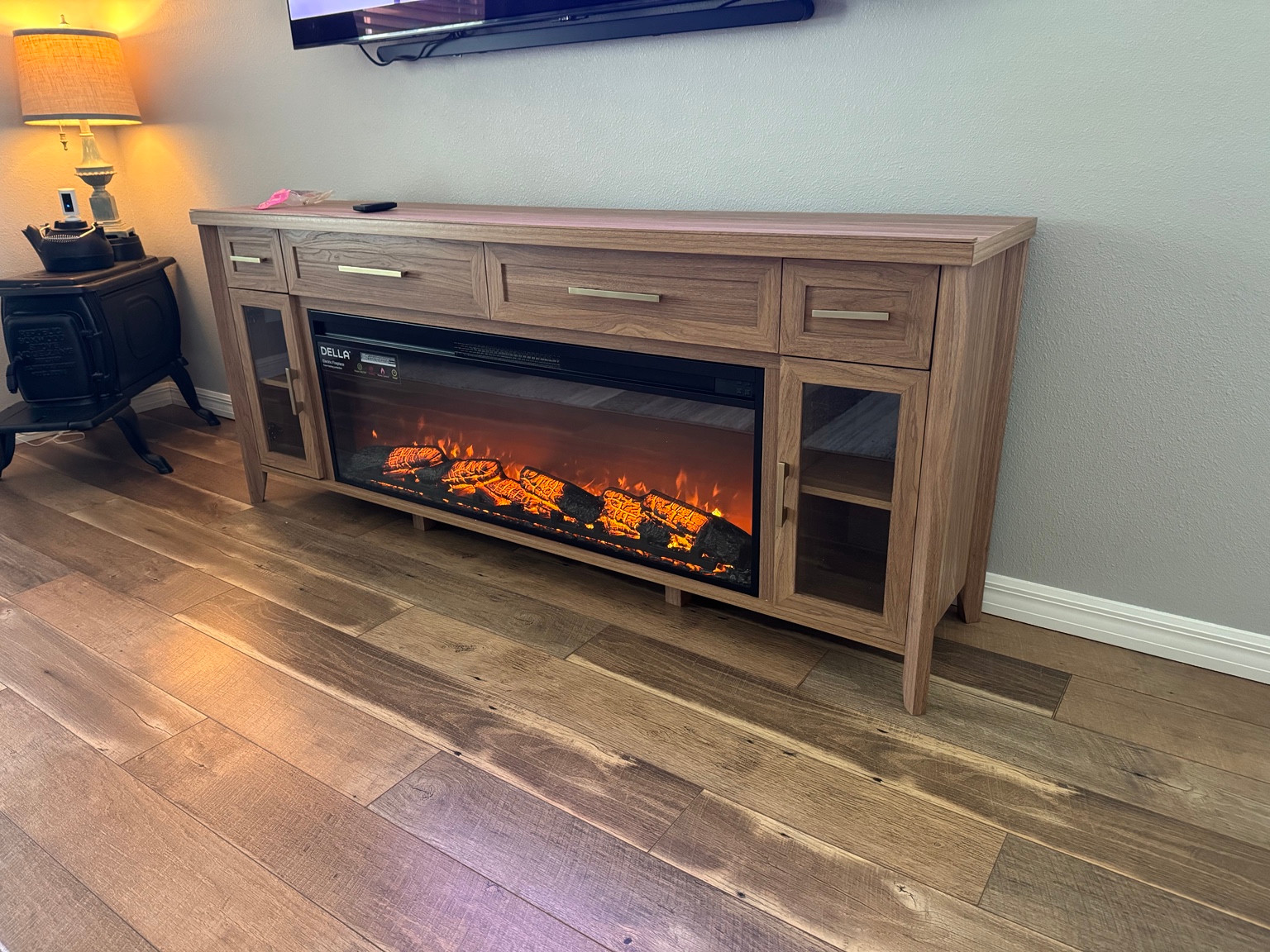 Assembled wood-look entertainment console with an electric fireplace insert