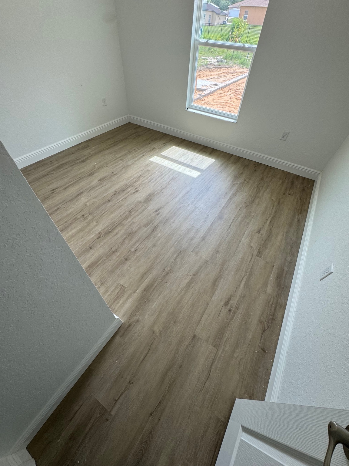 Light wood-look luxury vinyl plank floor in a bright room